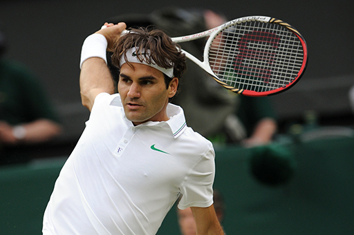 Roger Federer hits a one-handed backhand during the semi-final match against Novak Djokovic.