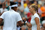 Petra Kvitova and Akgul Amanmuradova high five eachother at the conclusion of their opening round match.