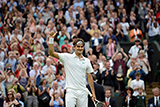 Roger Federer waves to the crowd after defeating Novak Djokovic and advancing to the Championships.